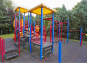 Thumbnail 26 of 46 - a colorful playground with benches and a swing set at Troutdale Terrace, Troutdale, Oregon