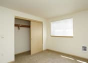 Thumbnail 34 of 46 - an empty room with a closet and a window at Troutdale Terrace, Troutdale, OR 97060