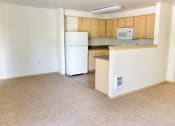 Thumbnail 38 of 46 - an empty kitchen with a microwave and a refrigerator at Troutdale Terrace, Troutdale,  97060