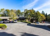 Thumbnail 10 of 49 - cars in a parking lot in front of an apartment in at Whisperwood, Washington 98168