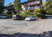Thumbnail 14 of 49 - an empty parking lot in front of an apartment building at Whisperwood, Washington