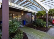 Thumbnail 16 of 49 - a sidewalk in front of a building with awning at Whisperwood, Seattle, 98168