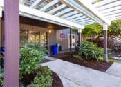 Thumbnail 17 of 49 - a walkway in front of a building with a porch at Whisperwood, Seattle, WA 98168