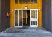 Thumbnail 24 of 49 - Front door of a yellow apartment at Whisperwood, Seattle, WA