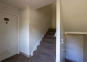 Thumbnail 28 of 49 - stairs in a home with white walls and carpet at Whisperwood, Seattle