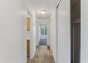 Thumbnail 29 of 49 - a long hallway with a door to a bedroom and a window at Whisperwood, Washington 98168