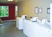 Thumbnail 33 of 49 - washers and dryers in the laundry room at Whisperwood, Washington 98168