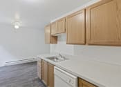 Thumbnail 34 of 49 - a kitchen with a sink and wooden cabinets at Whisperwood, Seattle, Washington