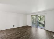 Thumbnail 37 of 49 - an empty living room with a sliding glass door to a patio at Whisperwood, Seattle, 98168