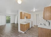 Thumbnail 39 of 49 - an empty kitchen with wooden cabinets and a white counter top at Whisperwood, Seattle, 98168