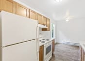 Thumbnail 42 of 49 - a kitchen with white appliances and wooden cabinets at Whisperwood, Washington