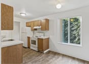 Thumbnail 44 of 49 - a kitchen with wooden cabinets and a window at Whisperwood, Seattle, WA 98168