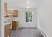 Thumbnail 45 of 49 - an empty kitchen with a window and wooden floors at Whisperwood, Seattle, WA 98168