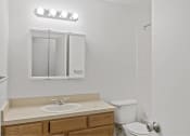 Thumbnail 47 of 49 - a bathroom with a sink toilet and a mirror at Whisperwood, Seattle