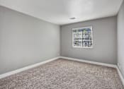 Thumbnail 45 of 63 - A room with a window and carpeted floor at The Henley Apartments, Suisun City, California