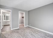 Thumbnail 47 of 63 - A room with a carpeted floor and a closet with a mirror at The Henley Apartments, California
