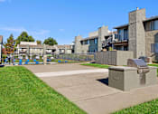 Thumbnail 54 of 63 - A concrete structure sits in the middle of a grassy area in front of apartment buildings at The Henley Apartments, Suisun City, 94585