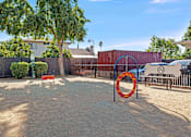 Thumbnail 15 of 63 - A playground with a red and orange ring on a pole at The Henley Apartments, Suisun City, 94585