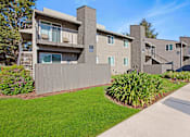 Thumbnail 57 of 63 - Apartment complex with a green lawn in front at The Henley Apartments, Suisun City, California