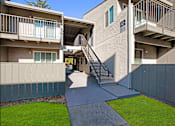 Thumbnail 56 of 63 - A concrete building with a green lawn in front at The Henley Apartments, Suisun City, CA