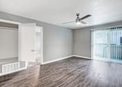 Thumbnail 33 of 63 - A room with a ceiling fan and a window with blinds at The Henley Apartments, California