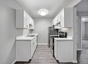Thumbnail 21 of 63 - A kitchen with white cabinets and appliances at The Henley Apartments, Suisun City, CA, 94585