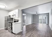 Thumbnail 20 of 63 - A kitchen with a refrigerator, oven, and sink at The Henley Apartments, Suisun City, CA