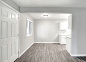 Thumbnail 40 of 63 - A white room with a wooden floor and a door at The Henley Apartments, Suisun City, 94585