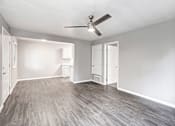 Thumbnail 36 of 63 - A room with a ceiling fan and light fixture, and a door to the right at The Henley Apartments, Suisun City, 94585