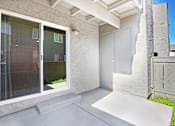 Thumbnail 37 of 63 - A patio area with a white door and a window at The Henley Apartments, Suisun City