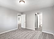 Thumbnail 34 of 63 - A room with a carpeted floor and a ceiling light at The Henley Apartments, California, 94585
