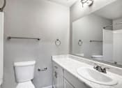Thumbnail 52 of 63 - A white toilet is next to a sink in a bathroom at The Henley Apartments, Suisun City, 94585
