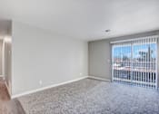 Thumbnail 30 of 63 - A room with a carpeted floor and a sliding glass door at The Henley Apartments, California, 94585