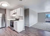 Thumbnail 18 of 63 - A kitchen with white appliances and cabinets at The Henley Apartments, California, 94585