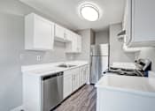 Thumbnail 19 of 63 - A modern kitchen with white cabinets and stainless steel appliances at The Henley Apartments, Suisun City, CA, 94585