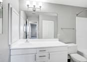 Thumbnail 51 of 63 - A white bathroom with a sink, toilet, and bathtub at The Henley Apartments, California