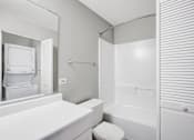 Thumbnail 50 of 63 - A white toilet sits next to a white sink in a bathroom at The Henley Apartments, Suisun City, CA, 94585