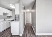 Thumbnail 24 of 63 - A kitchen with white cabinets and a white sink at The Henley Apartments, California, 94585