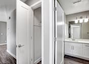 Thumbnail 48 of 63 - A white bathroom with a mirror and a sink at The Henley Apartments, Suisun City