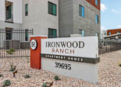 Thumbnail 32 of 32 - A sign for Ironwood Ranch Apartment Homes stands in front of a building at Ironwood Ranch Apartments,Maricopa,AZ