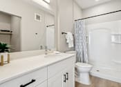 Thumbnail 27 of 32 - A white bathroom with a sink, toilet, and bathtub at Ironwood Ranch Apartments,Arizona