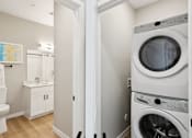 Thumbnail 28 of 32 - A white washing machine in a laundry room at Ironwood Ranch Apartments,Maricopa