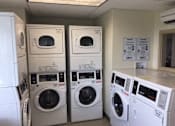 Thumbnail 9 of 10 - A row of washing machines in a laundromat at Tabco Towers Apartments, Towson, 21286