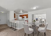 Thumbnail 17 of 24 - A modern kitchen with a dining table set up with chairs at The Villages on Millenia Apartments, Florida