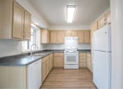 Thumbnail 19 of 29 - Kitchen with white appliances at Bridge Meadows Redmond Apartments, Oregon