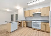 Thumbnail 17 of 29 - Kitchen with wooden cabinets at Bridge Meadows Redmond Apartments, Redmond, OR, 97756