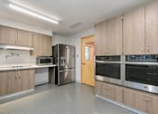 Thumbnail 14 of 29 - Kitchen with stainless steel appliances at Bridge Meadows Redmond Apartments, Redmond