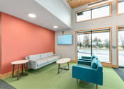 Thumbnail 11 of 29 - Room with a blue couch at Bridge Meadows Redmond Apartments, Redmond, OR, 97756