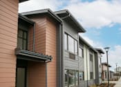 Thumbnail 1 of 29 - Row of houses with sidewalk at Bridge Meadows Redmond Apartments, Redmond, OR, 97756