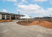 Thumbnail 7 of 29 - Playground area at Bridge Meadows Redmond Apartments, Redmond, OR